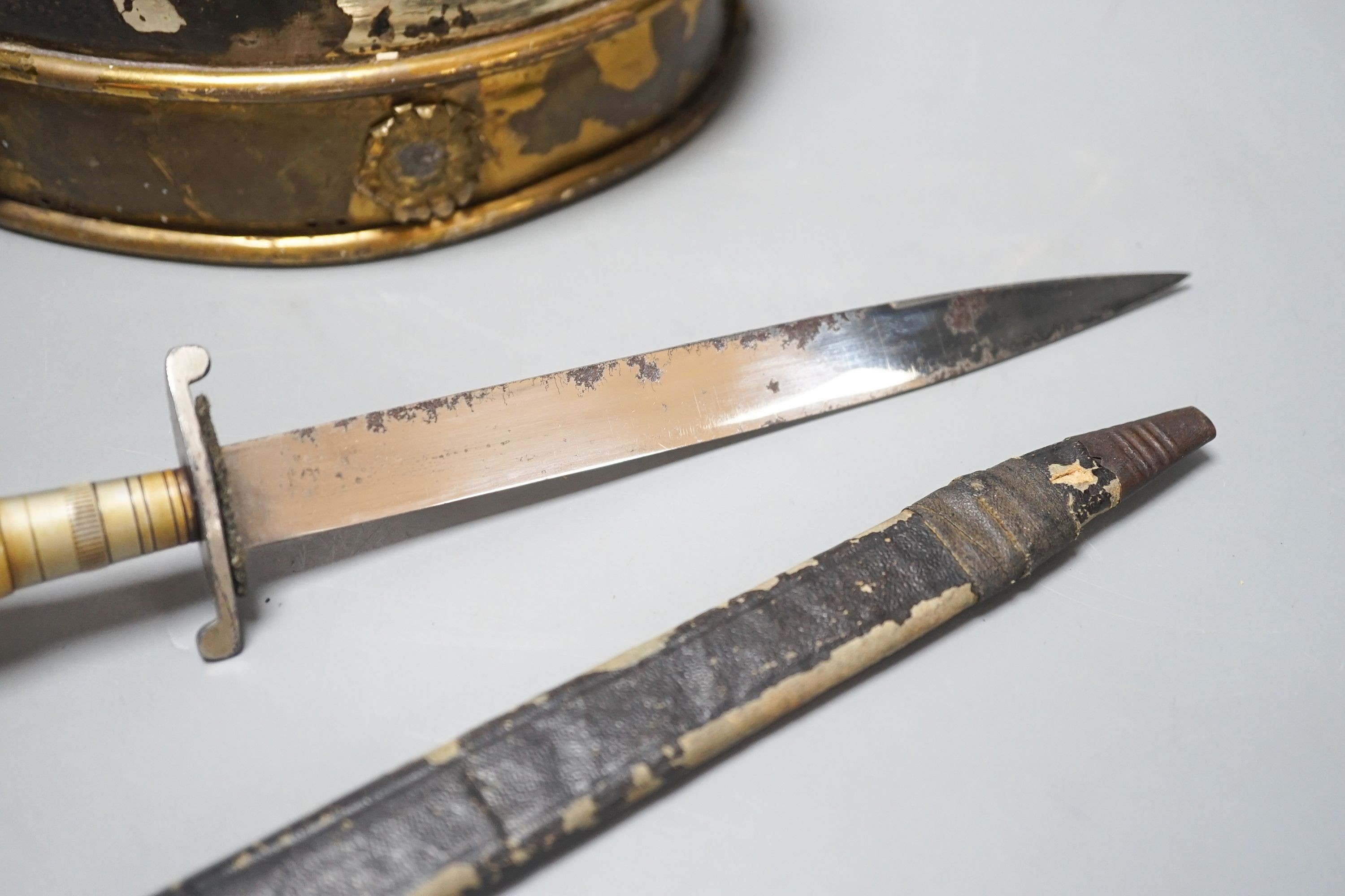 A Middle-Eastern silvered metal and brass helmet and a dagger in sheath